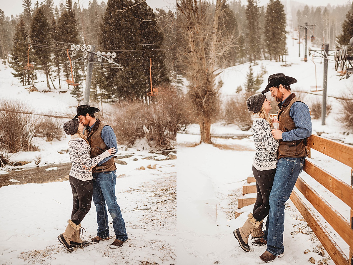 cute couple in beanie and sweater lean against fence to share a kiss in western winter engagement shoot in new mexico