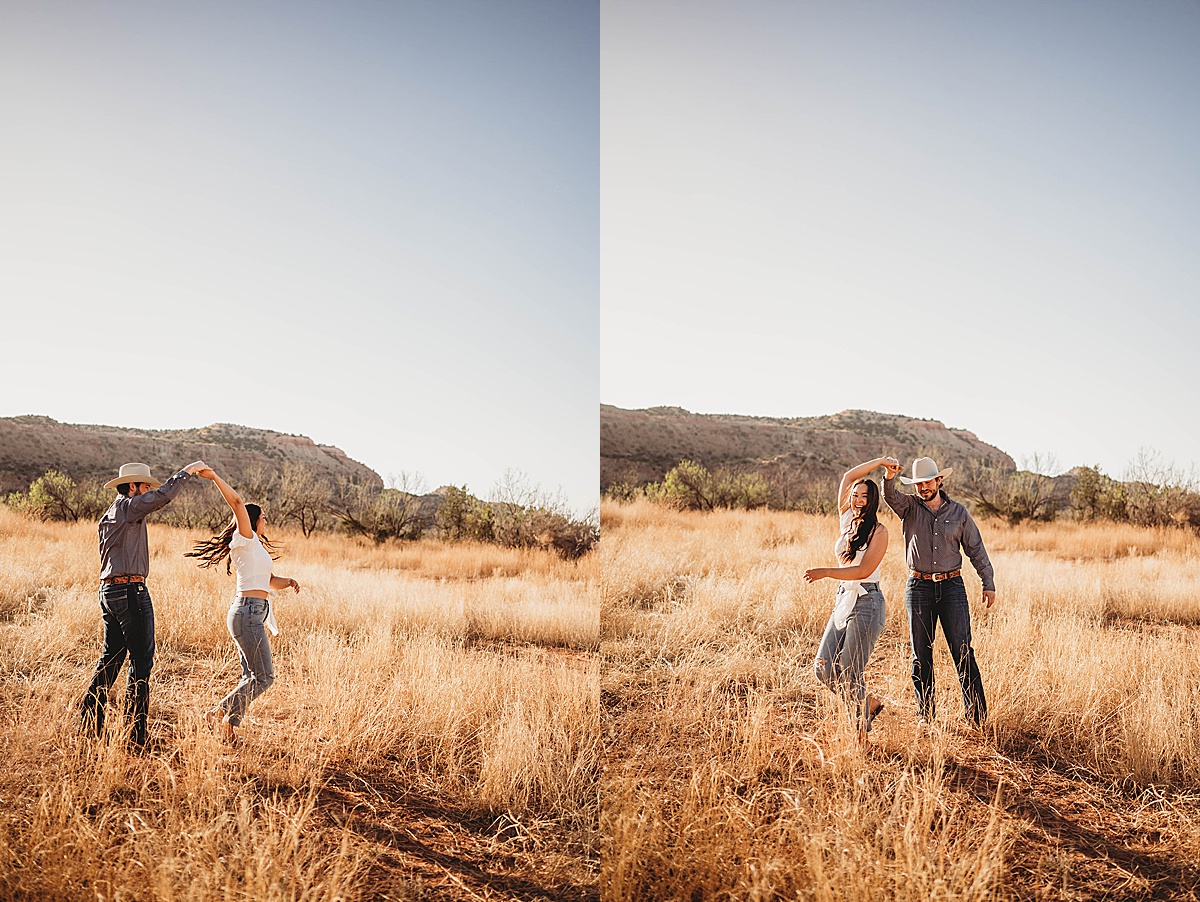 young couple twirls and dances in field during golden summer engagement shoot