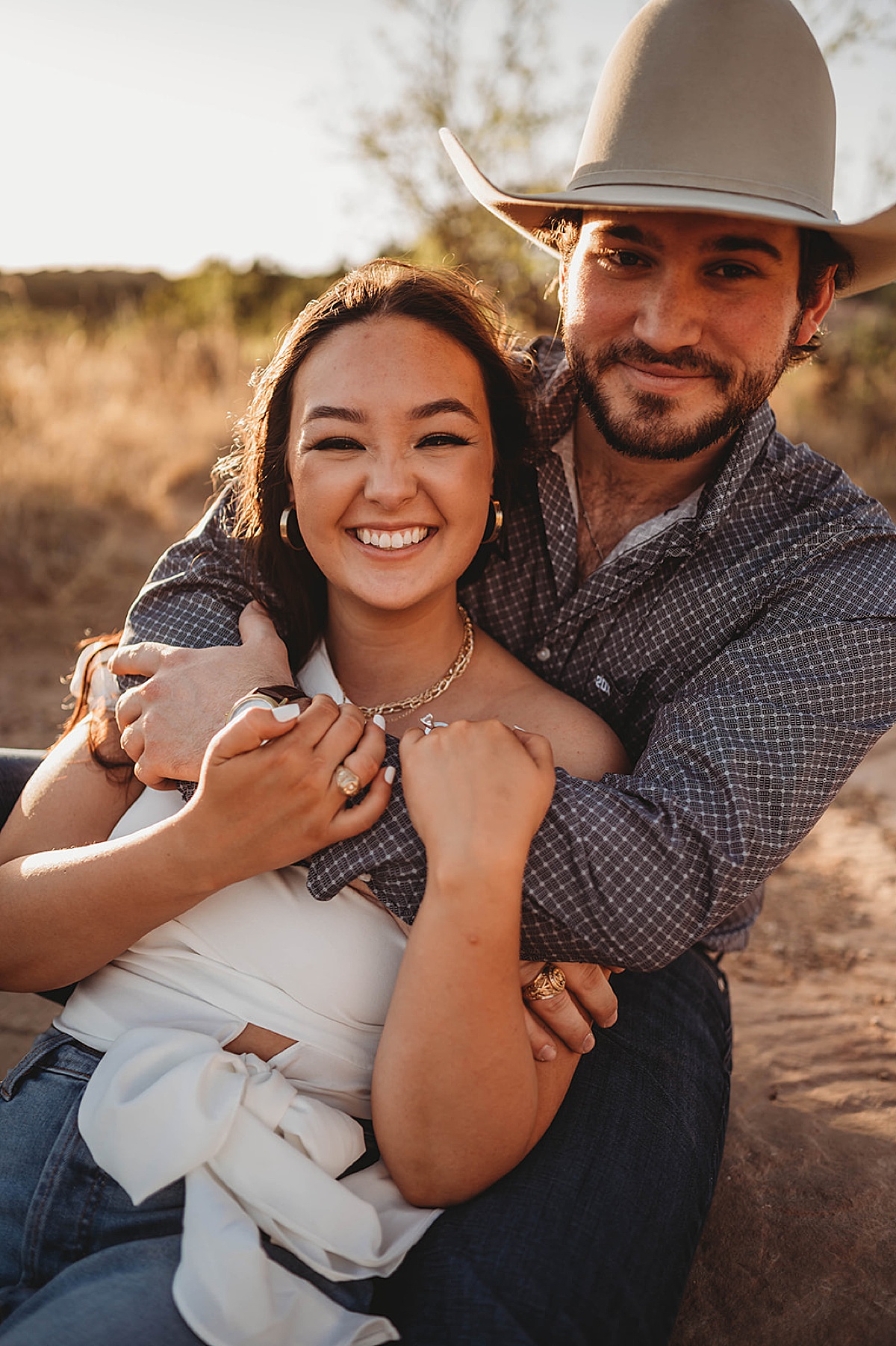 engaged couple smiles at palo duro canyon shoot by Three Feather Photo Co