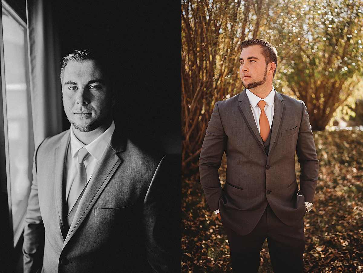 Groom poses in gray suit and orange tie before boho Red River Autumn Wedding