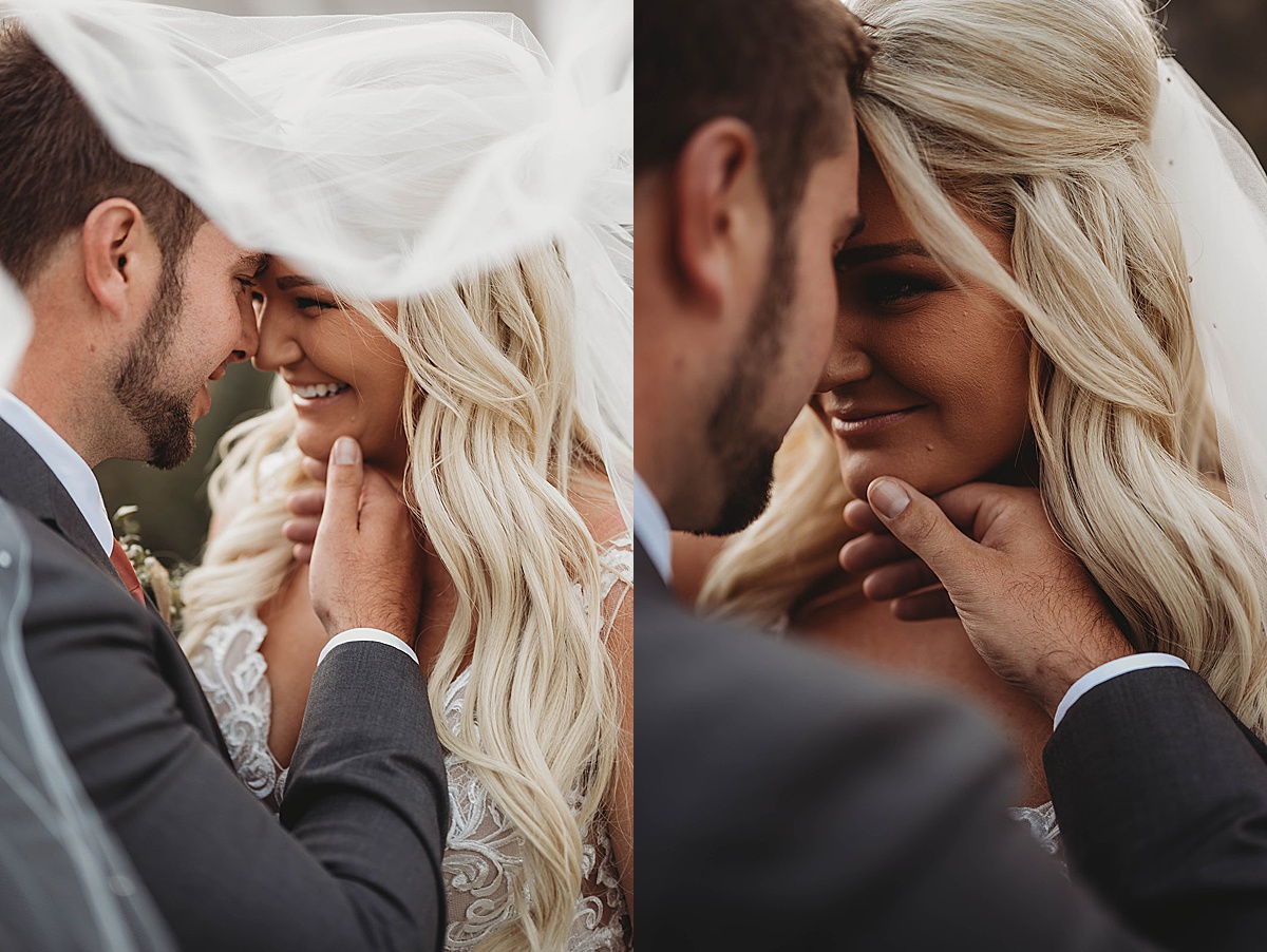 Groom caresses bride's face under wedding veil after red river wedding shot by Three Feather Photo Co
