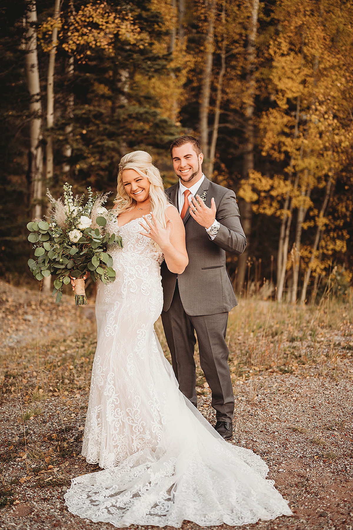 bride and groom show off rings in front of autumn leaves after ceremony shot by palo duro canyon elopement photographer