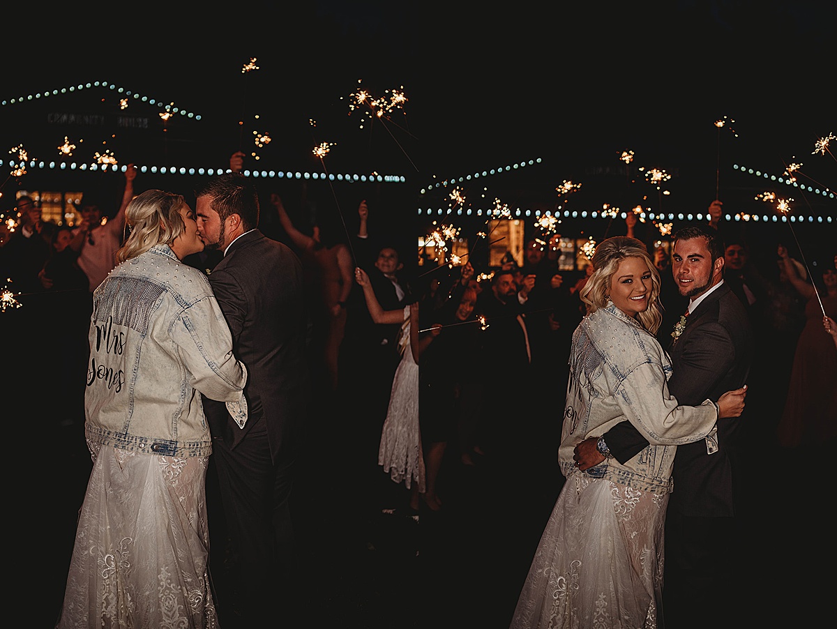 bride and groom kiss in front of guests holding sparklers after wedding shot by palo duro canyon elopement photographer