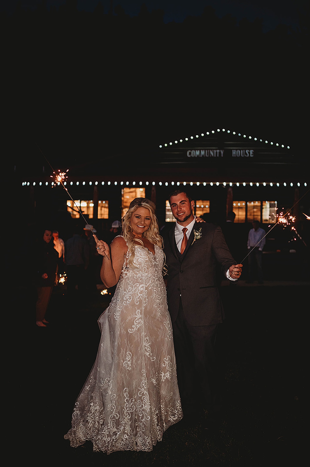 bride and groom pose with sparklers after boho wedding shot by palo duro canyon elopement photographer