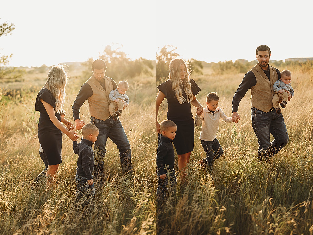 husband and wife walk through field with kids during family portraits at creek house honey farm