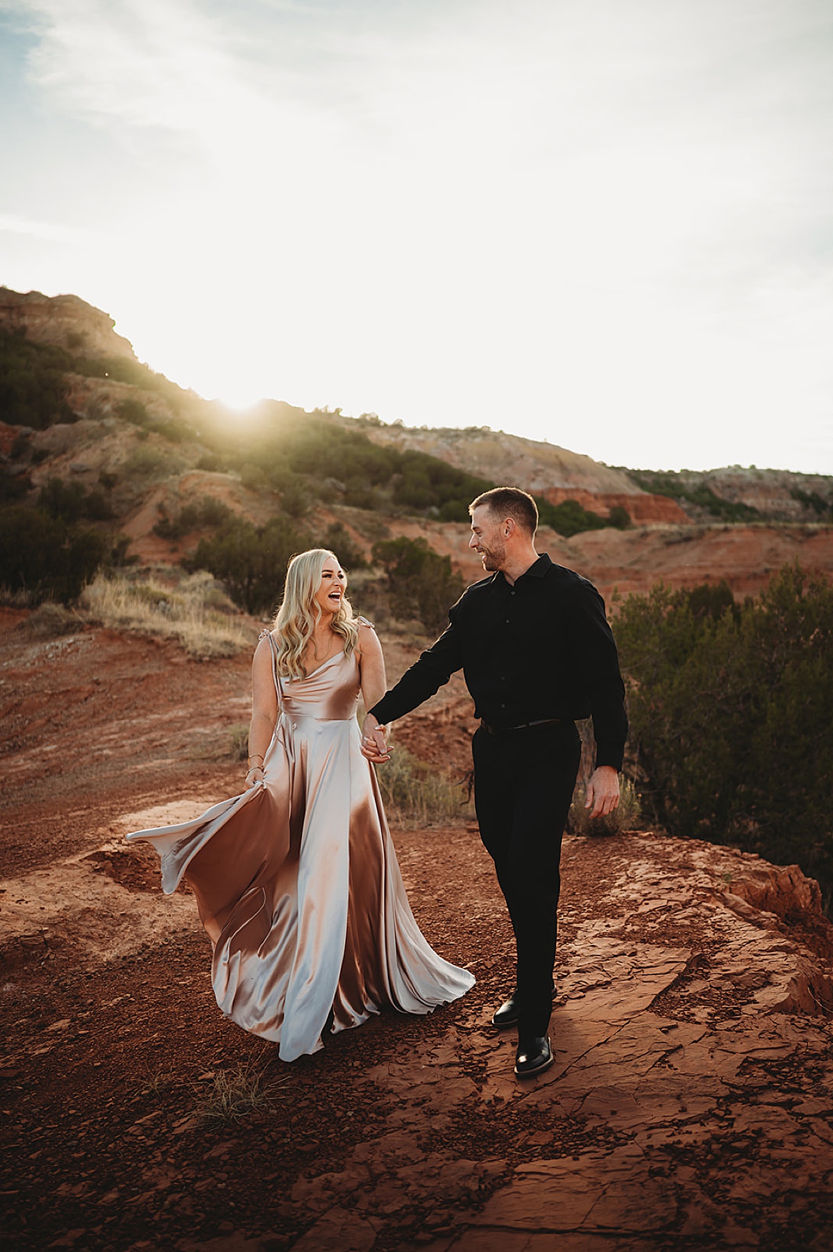 couple in elegant evening wear pose in canyon during quicksilver and moonlight engagement session