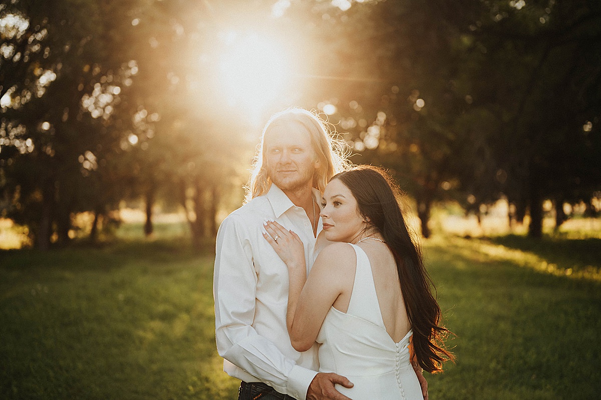 boho artsy couple pose in golden hour twilight after outdoor sweet summer elopement