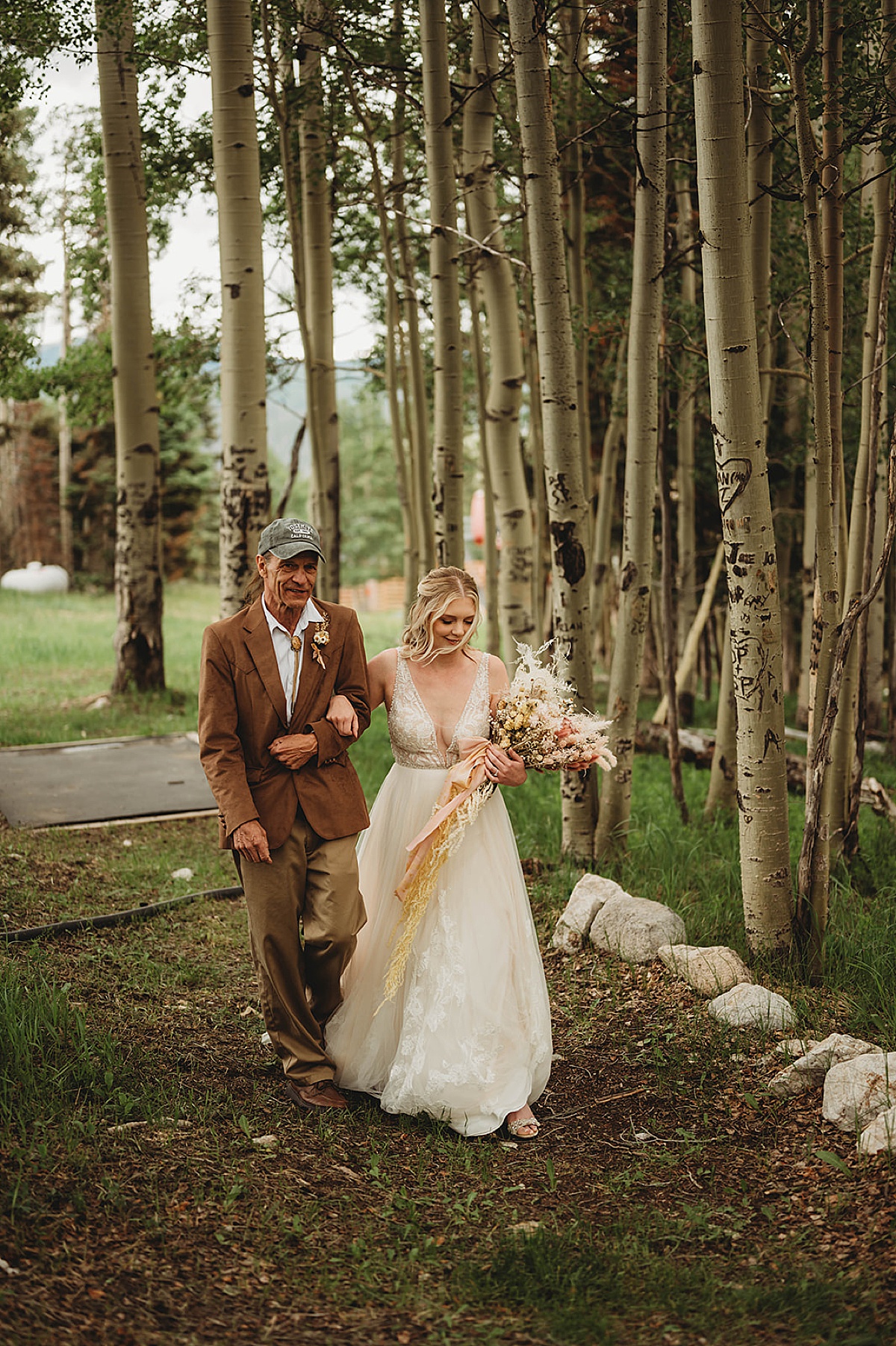bride and father walk between aspen trees during wedding shot by palo duro canyon elopement photographer