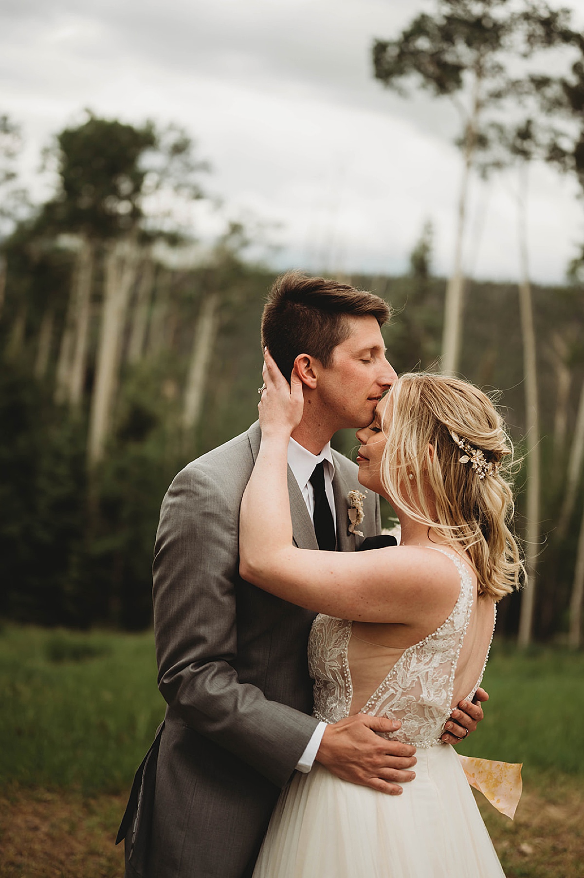 bride and groom kiss during boho mountain ceremony shot by Three Feather Photo Co