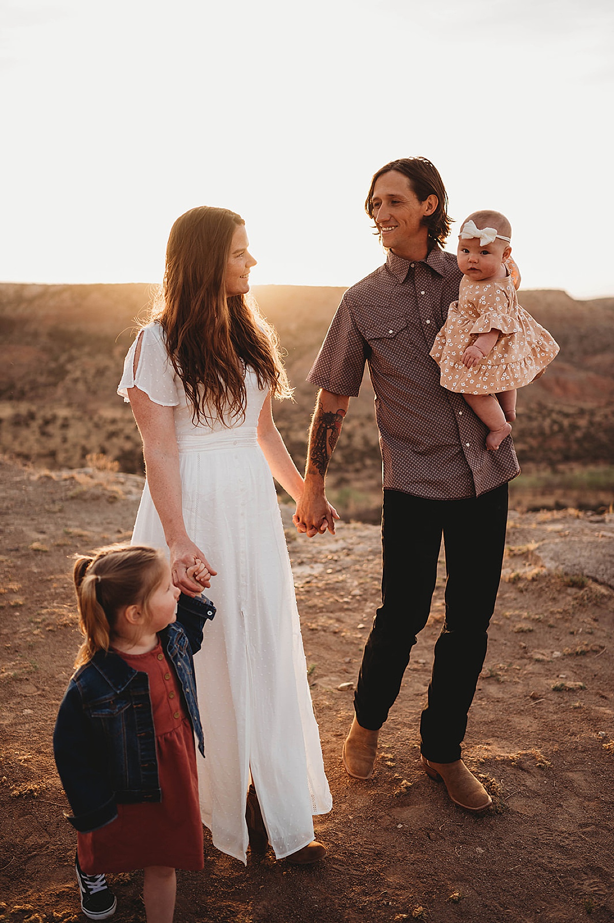 mom and dad pose with baby and toddler during boho sunrise adventure family portraits