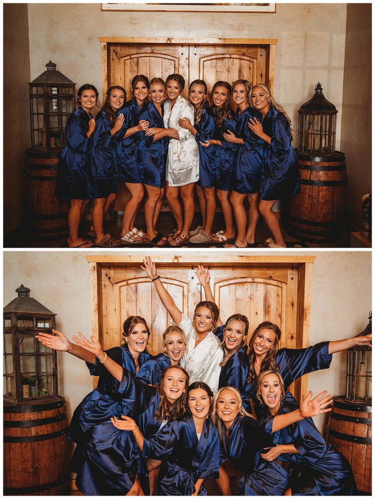 bridesmaids pose with bride by Three Feather Photo Co.