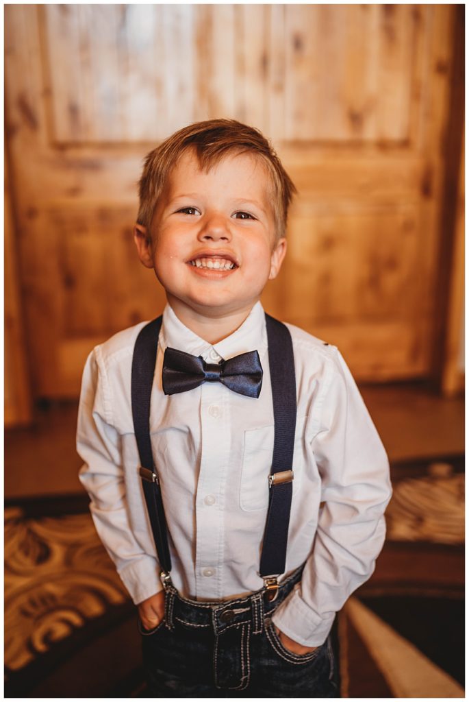 young boy smiles at Texas ranch wedding