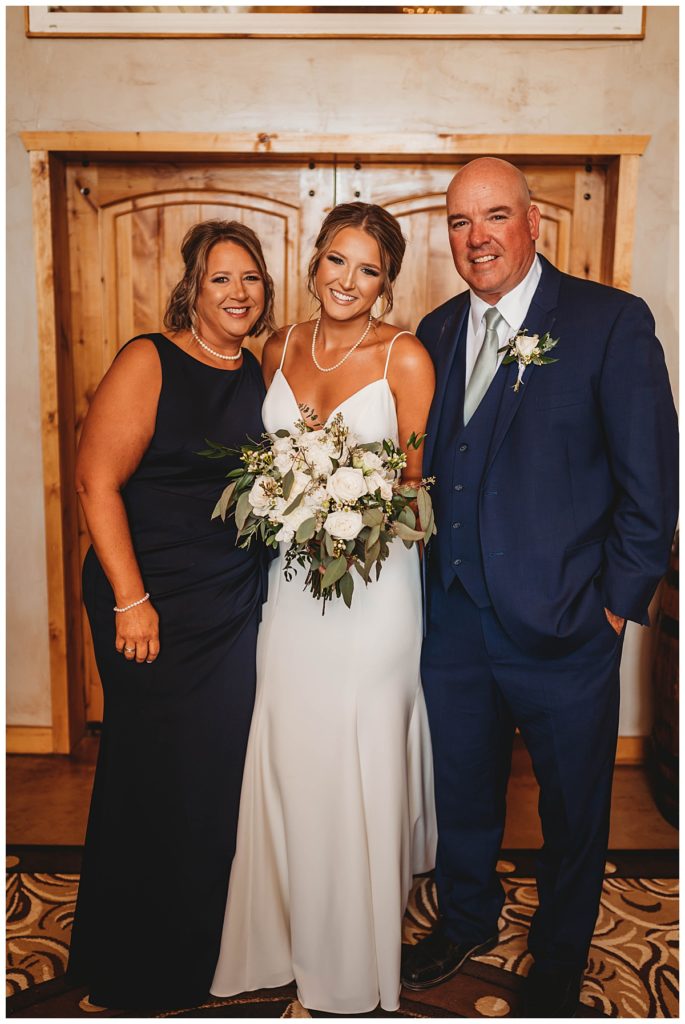 mother and father with bride by Three Feather Photo Co.