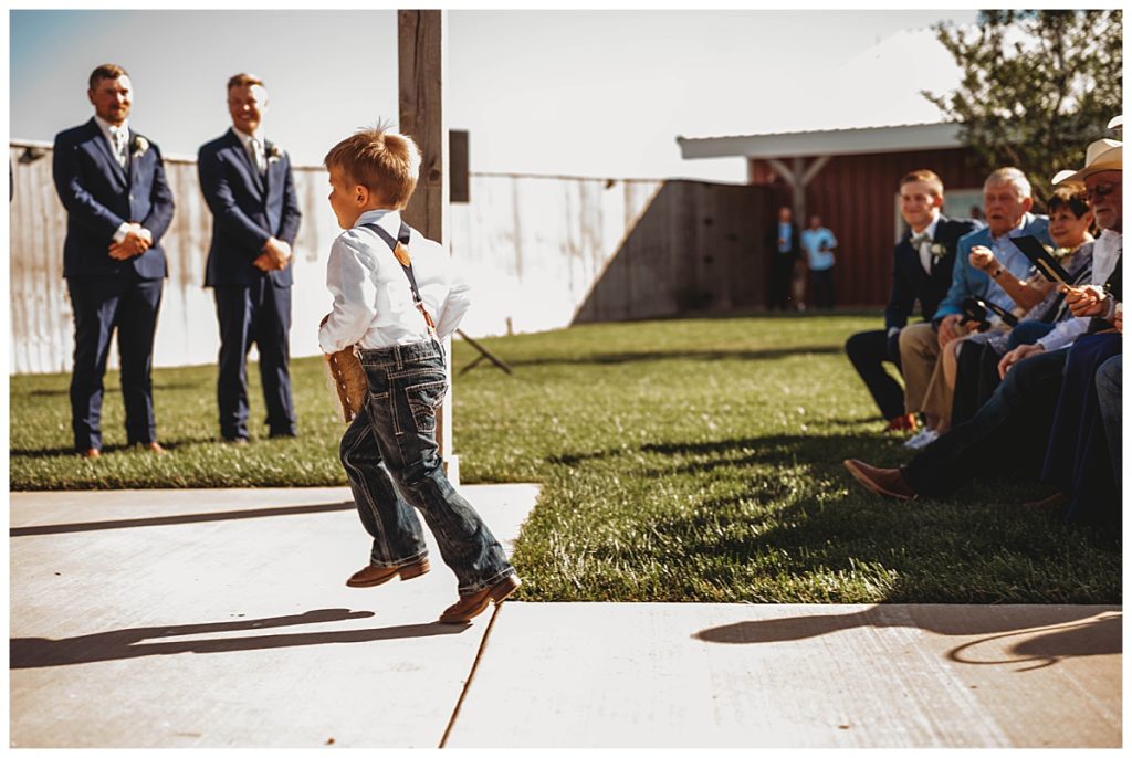boy runs down aisle by Palo Duro wedding photographer