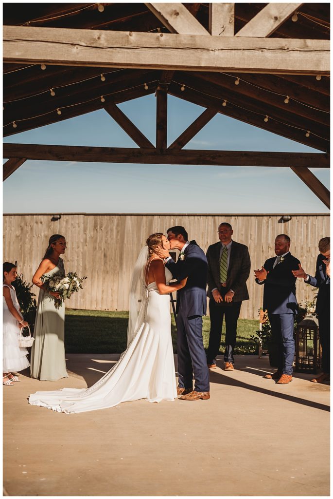 bride and groom kiss at Texas ranch wedding