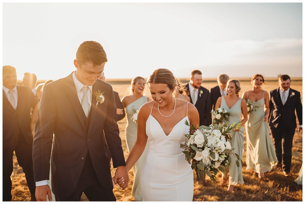 sun shines through bridal party by Three Feather Photo Co.