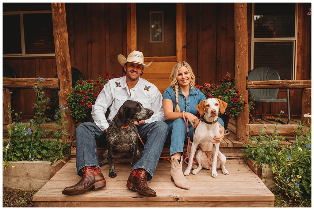 man and woman sitting with two dogs by Palo Duro Wedding Photographer