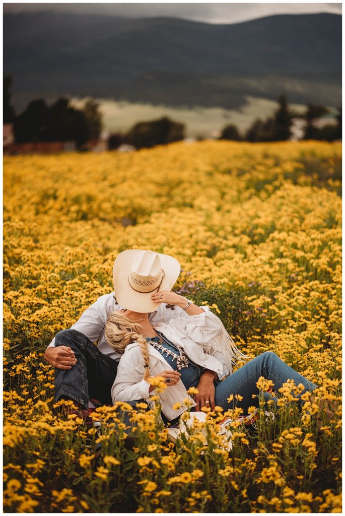 cowboy hat hides kiss in field in Red Rock couples session