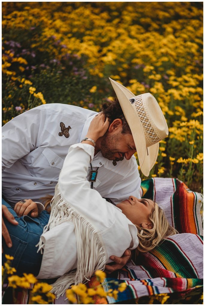 cowboy looks at lady on blanket by Palo Duro Wedding Photographer