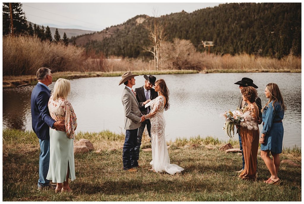 bride and groom with witnesses at Colorado cabin elopement