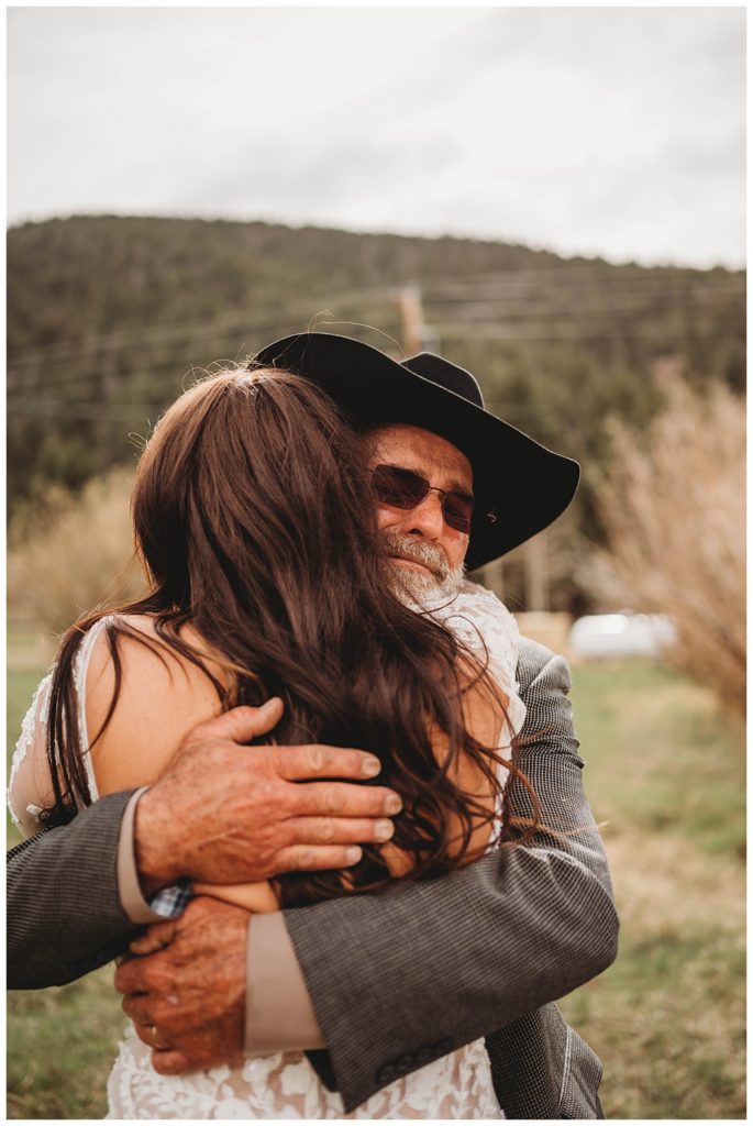 dad hugging daughter by Palo Duro wedding photographer