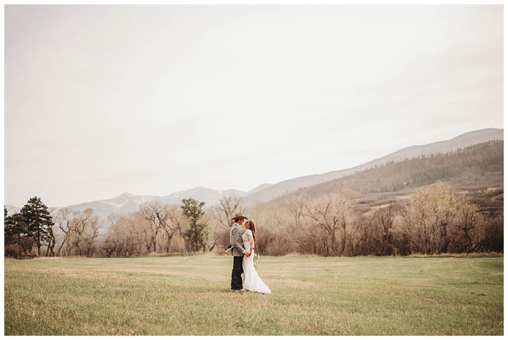 couple facing each other in field by Palo Duro wedding photographer