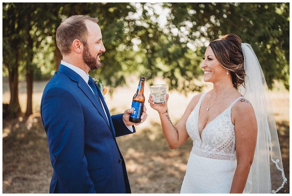 husband and wife toast with drinks by Three Feather Photo