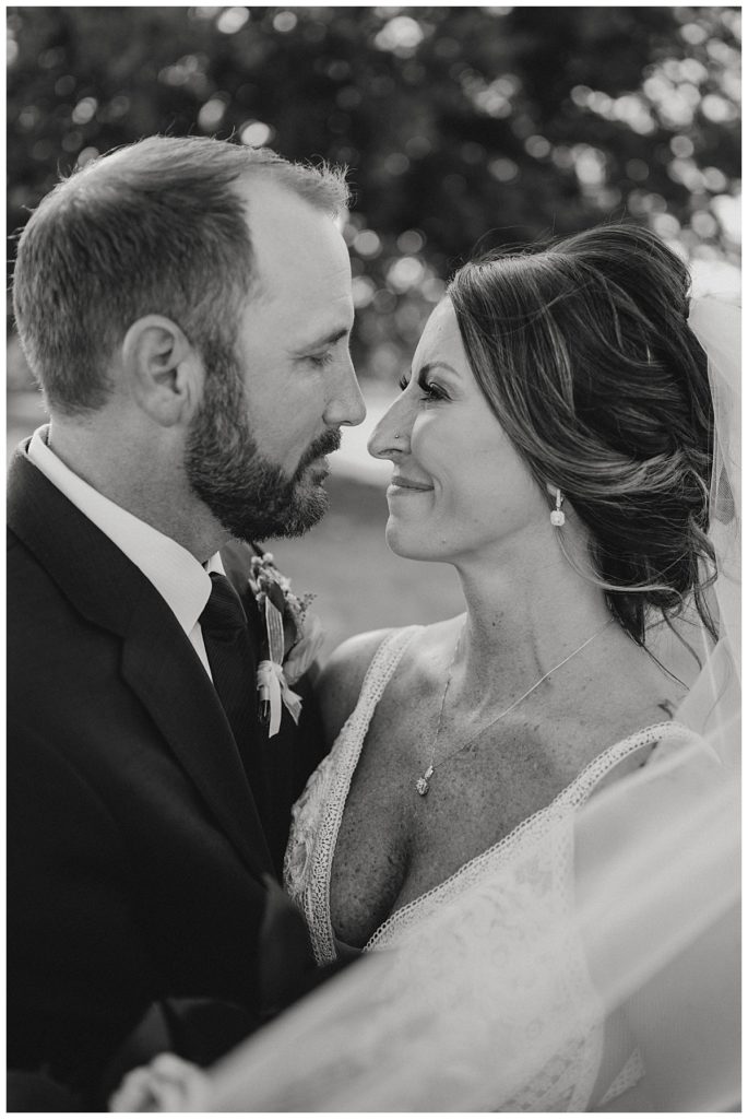 couple looks into each other's eyes by Three Feather Photo