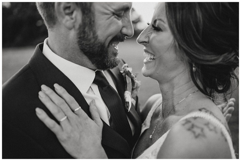 husband and wife laugh together by Three Feather Photo