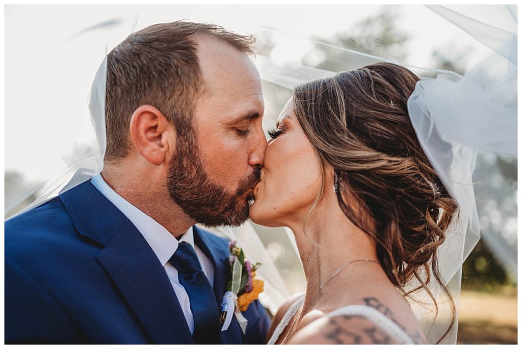 bride and groom kiss under veil at Austin villa wedding