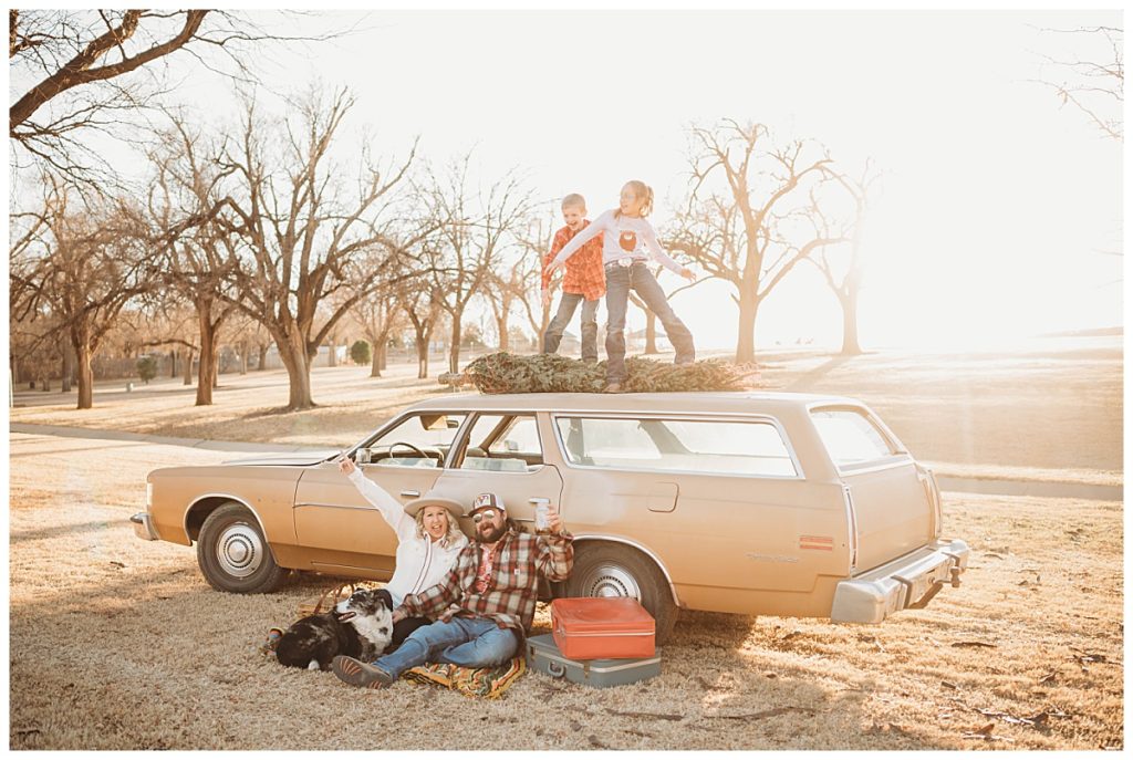 children dance on roof of station wagon while adults cheer below by Three Feather Photo