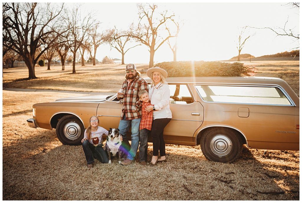 family stands together with dog at park by Palo Duro Wedding Photographer