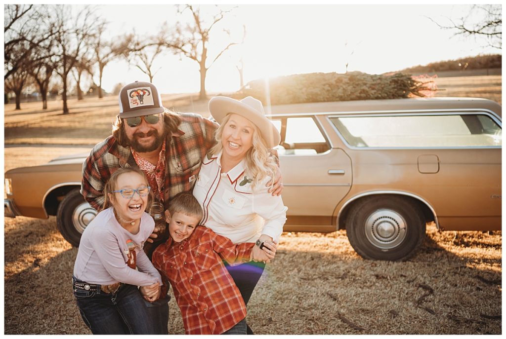 family smiles and laughs together in sunlight by Palo Duro Wedding Photographer