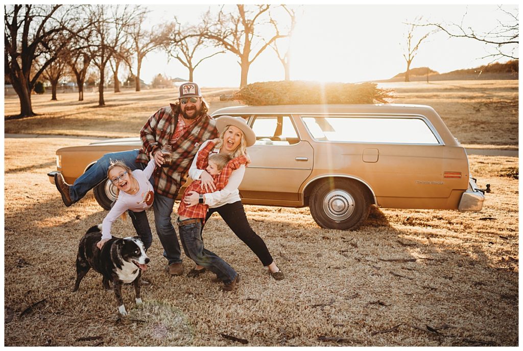 family hangs on each other and laughs with dog at family session in Amarillo