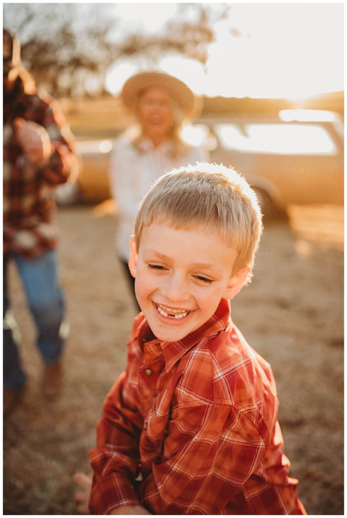 young boy missing front teeth grins by Palo Duro Wedding Photographer