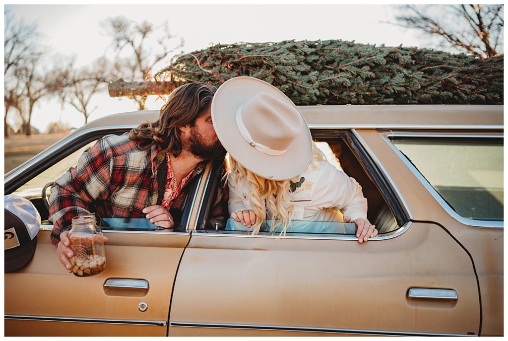 mom and dad kiss in the car by Three Feather Photo