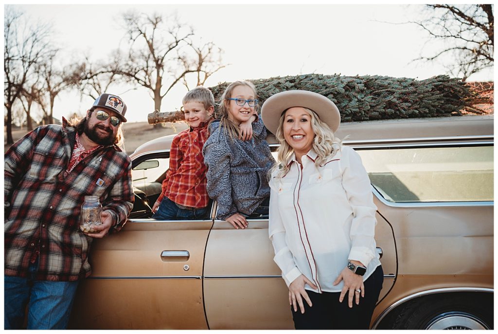family stands together around car by Palo Duro Wedding Photographer