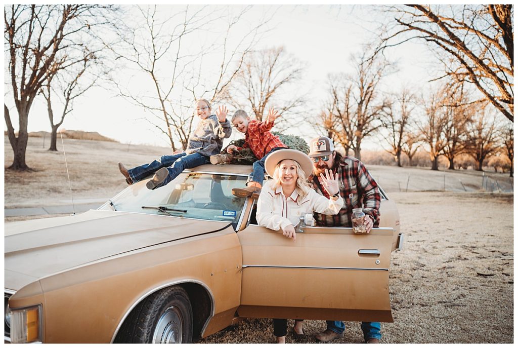 group waves as they sit on and around a station wagon by Palo Duro Wedding Photographer