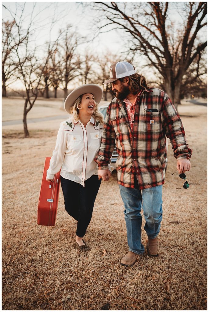 couple walks together looking at each other and smiling at family session in Amarillo