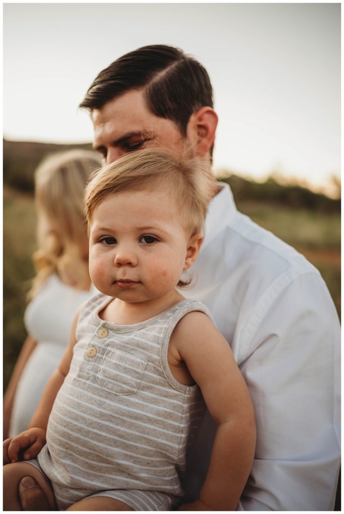 young boy in sleeveless romper held by dad by Palo Duro family photographer
