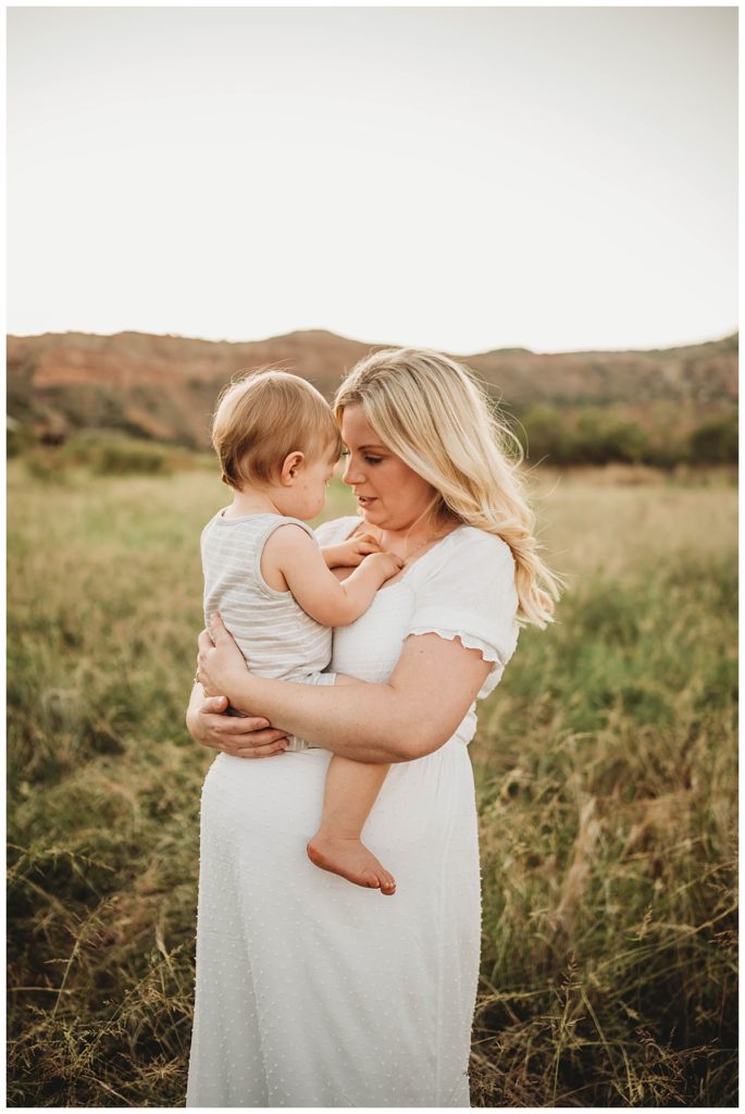 pregnant mother holds young son at canyon maternity shoot