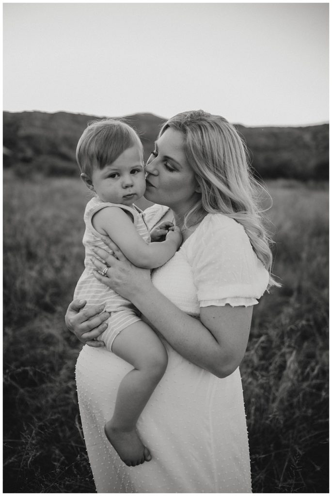 mom kisses son's cheek by Palo Duro family photographer