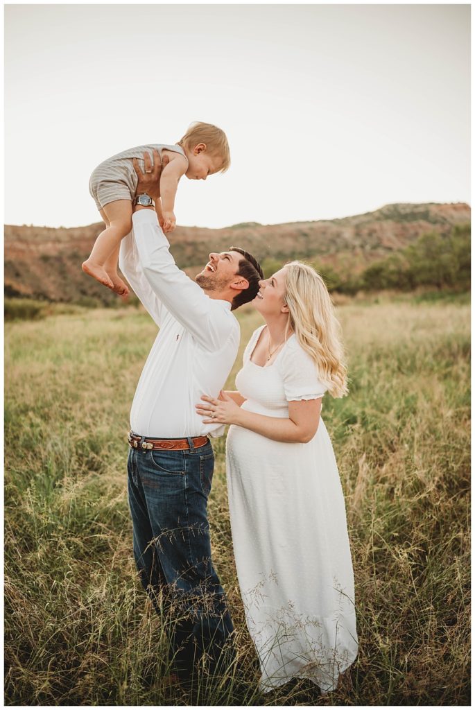 parents hold son up in the air by Palo Duro family photographer