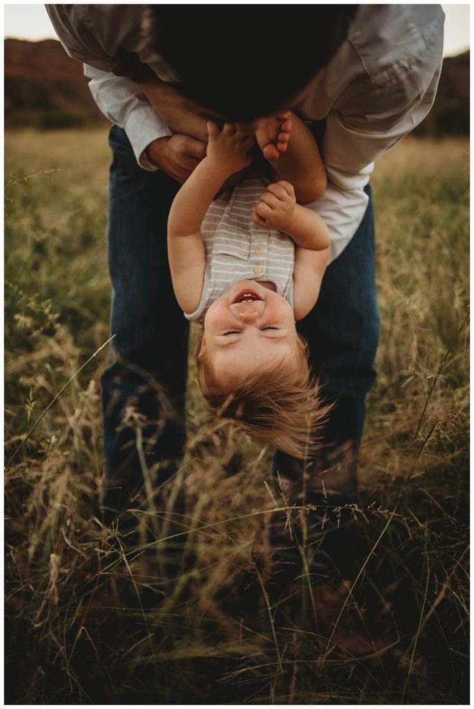dad flips grinning son upside down by Palo Duro family photographer
