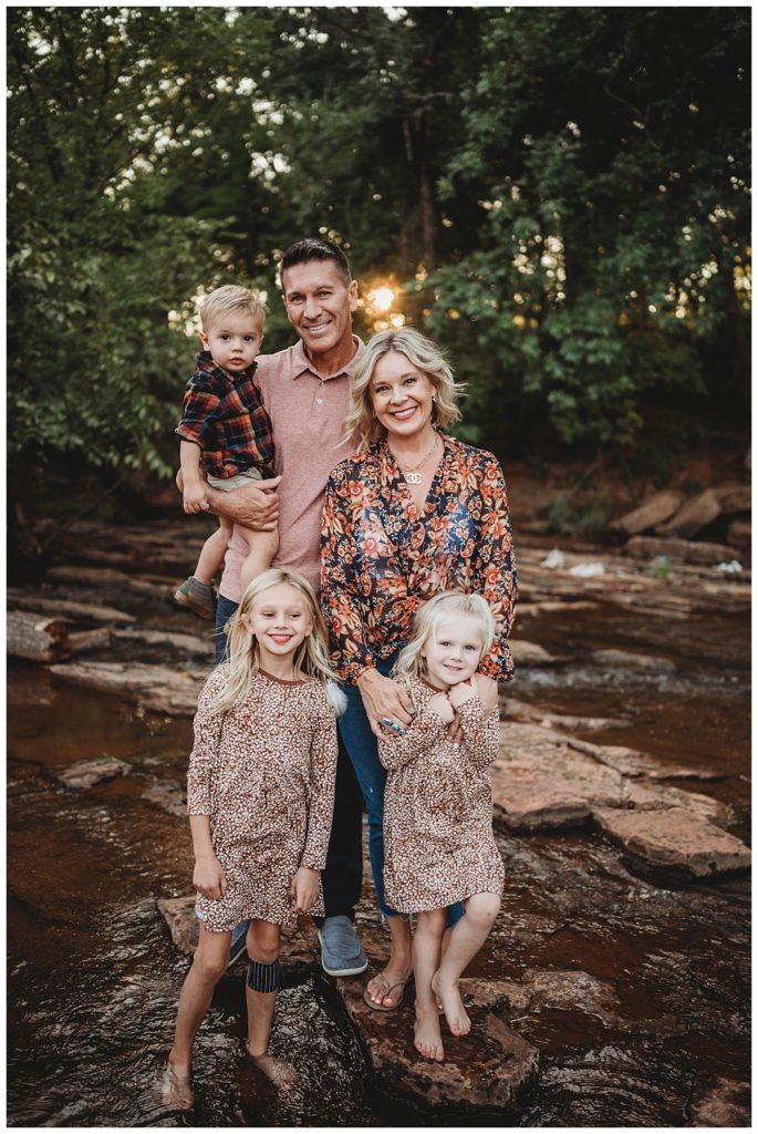 family stands in creek by Palo Duro wedding photographer