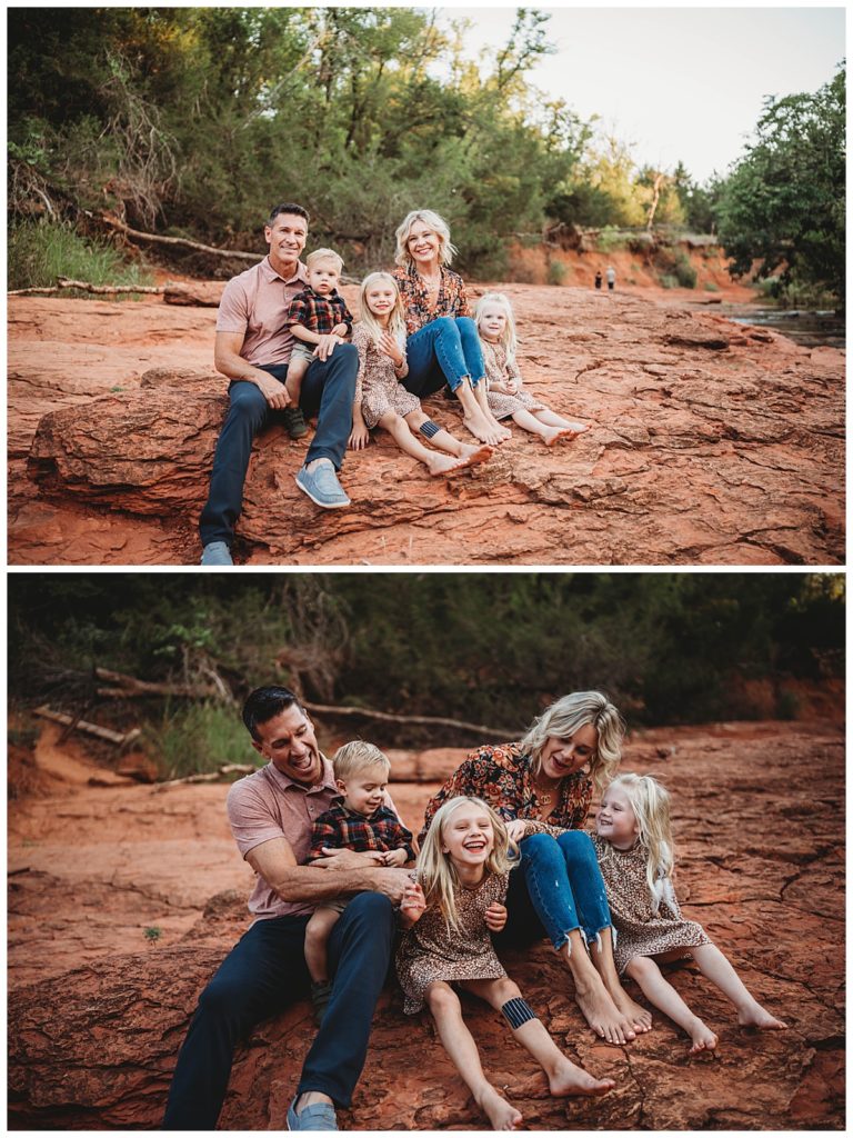 family sits together on rocks by stream by Three Feather Photo