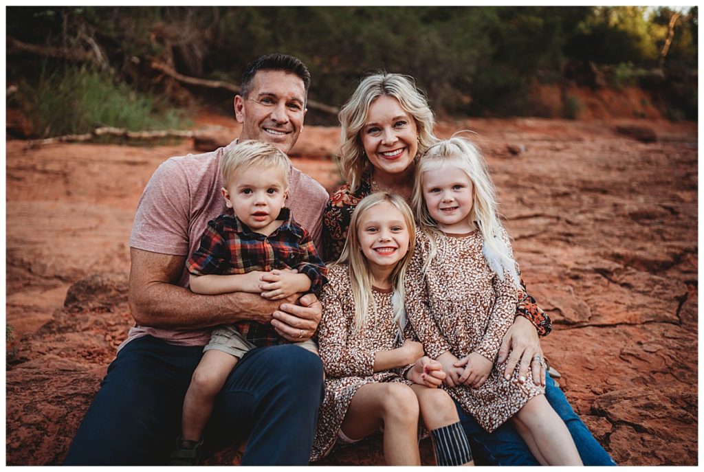 parents hold kids in their laps by Palo Duro wedding photographer