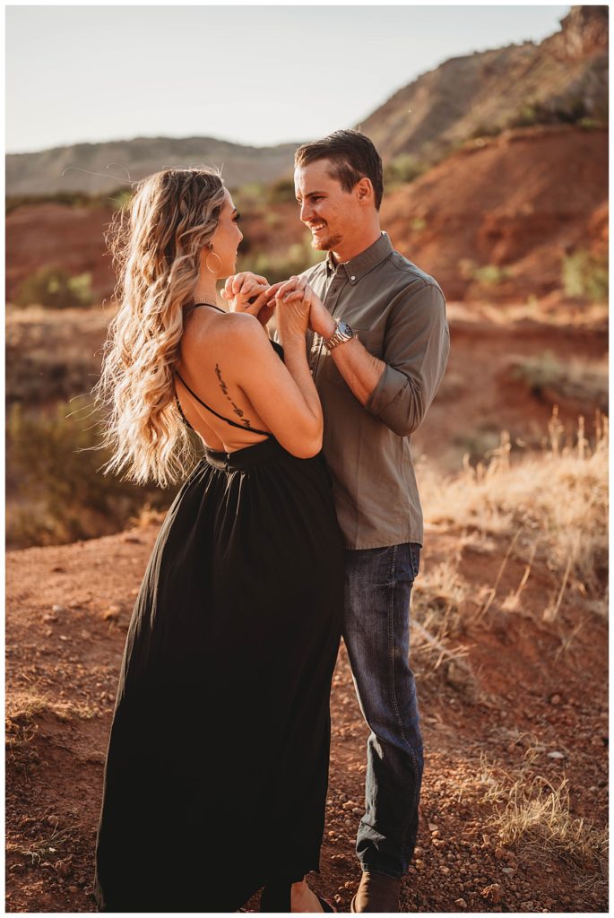 couple faces each other holding hands for Amarillo Portrait Photographer