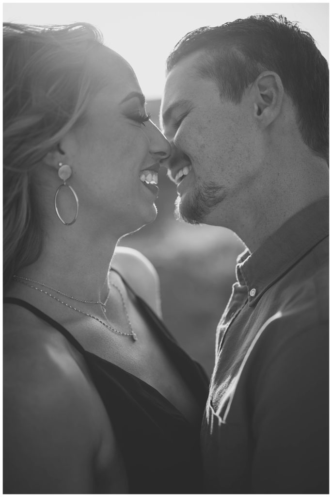 couple smiles while leaning in to kiss by Amarillo Portrait Photographer