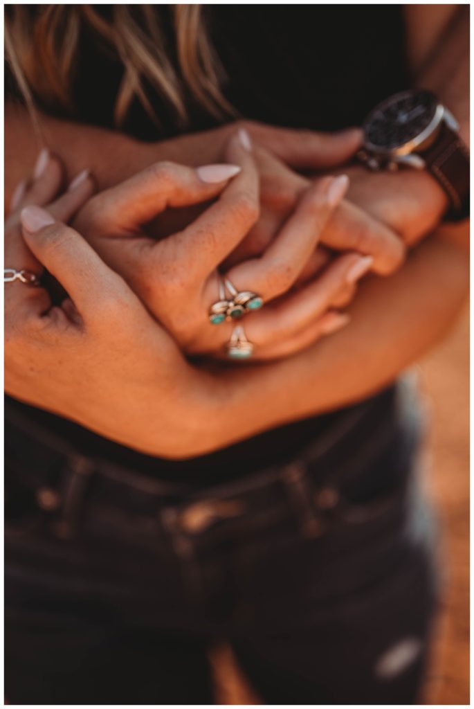 hands wrapped around woman for Palo Duro Canyon Couple Shoot
